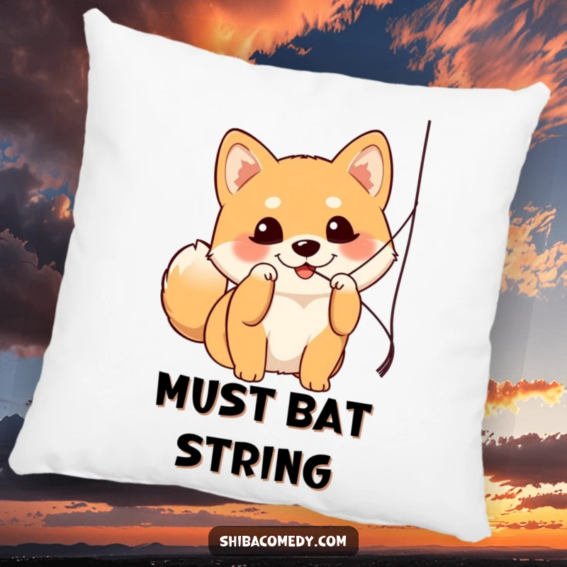 Funny Shiba Inu pillow showing a dog with bright eyes mid-bat at a string, radiating playful energy and comfort.