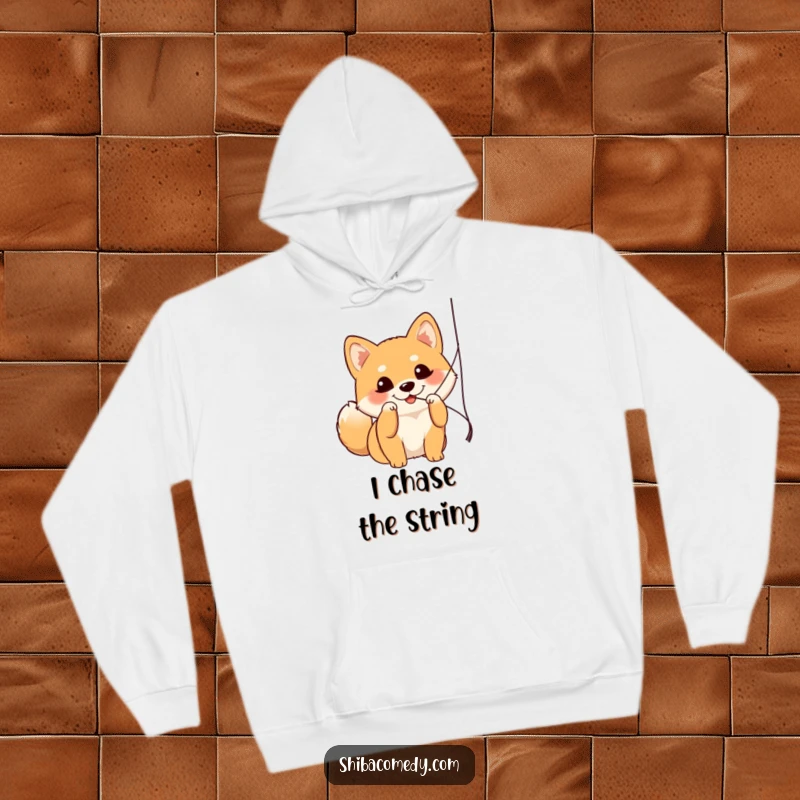 Funny Shiba Inu hoodie showing a happy dog with bright eyes batting at a string, embodying playful energy and warmth.