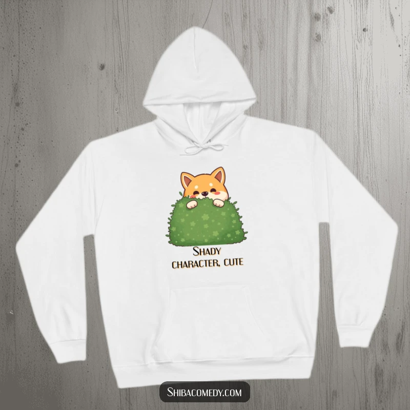 Funny mischievous Shiba Inu hoodie with a dog peeking out from behind a large bush, symbolizing secrecy and fun.