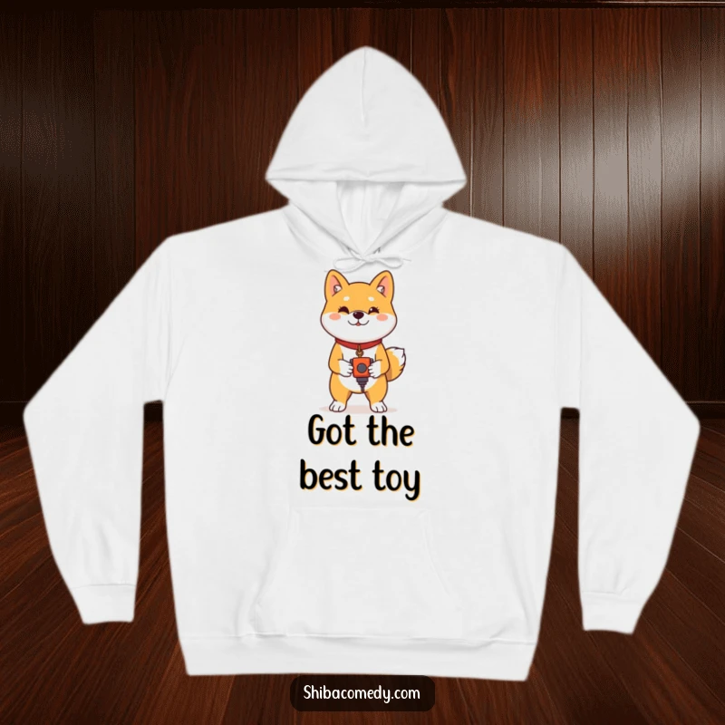 Funny Shiba Inu Hoodie: A proud Shiba Inu stands with a toy, offering a cozy and humorous feeling of victory.