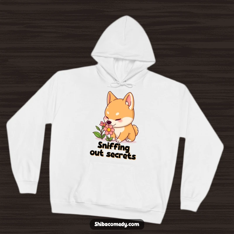 Funny Shiba Inu hoodie featuring a curious dog with perked ears sniffing a colorful flower, offering warmth and sweet, humorous charm.