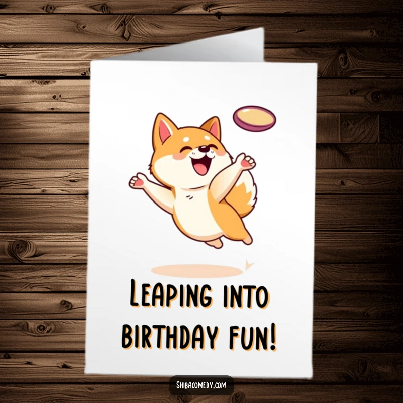 Funny free printable birthday card featuring a playful Shiba Inu leaping high to catch a frisbee mid-air.