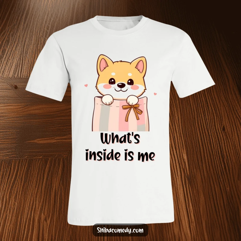 A funny t-shirt featuring a curious Shiba Inu dog peeking its head out from a gift bag, hinting at playful mischief.